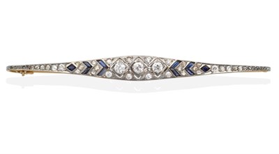 Lot 2151 - An Art Deco Sapphire and Diamond Bar Brooch, three old cut diamonds in milgrain frames, to a...