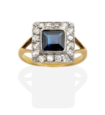 Lot 2152 - An Art Deco Sapphire and Diamond Cluster Ring, a square cut sapphire in a milgrain setting within a