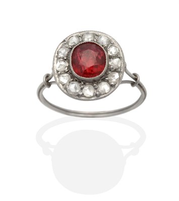 Lot 2155 - An Art Deco Red Spinel and Diamond Cluster Ring, an oval cut red spinel in a milgrain setting...