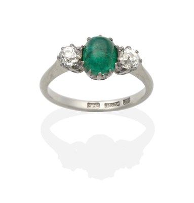 Lot 2160 - An Emerald and Diamond Three Stone Ring, an oval cabochon emerald in a claw setting, spaced by...