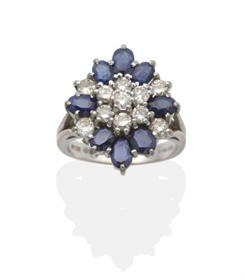 Lot 2174 - An 18 Carat White Gold Sapphire and Diamond Cluster Ring, a central cluster of seven round...