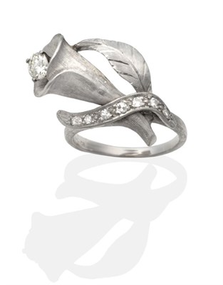 Lot 2182 - A Diamond Lily Ring, a round brilliant cut diamond in a claw setting within a brushed polished lily