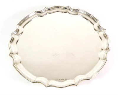 Lot 2272 - An Irish Shaped Circular Silver Salver, I.E.S., Dublin 2005, on four scroll supports, 30.5cm...