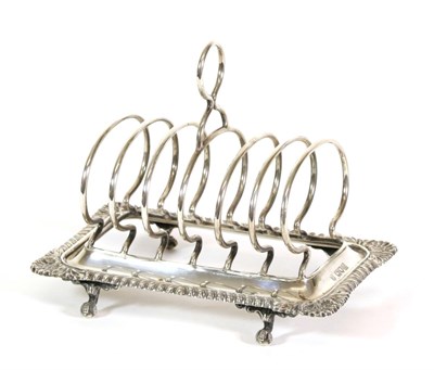 Lot 2335 - An Edwardian Silver Toastrack, Thomas Bradbury & Sons, London 1907, rectangular with shell, foliate