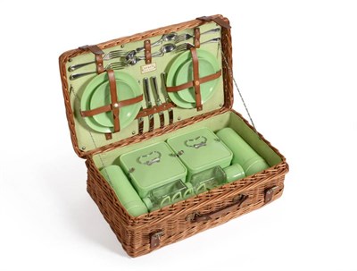 Lot 2004 - A Coracle Wicker Picnic Basket, circa 1950, containing green bandalasta settings for four...