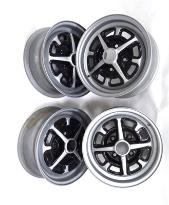 Lot 2022 - A Set of Four 14"; Four Stud Alloy Wheels, to fit an MG motorcar, repainted silver and black...