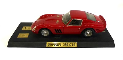 Lot 2039 - A Metal Diecast 1:12 Scale Model of a Ferrari 250 GTO, painted red, mounted on an ebonised...