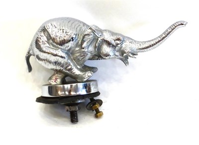 Lot 2095 - A Chrome Car Mascot in the Form of a Running Elephant, standing on a circular base, with rubber...