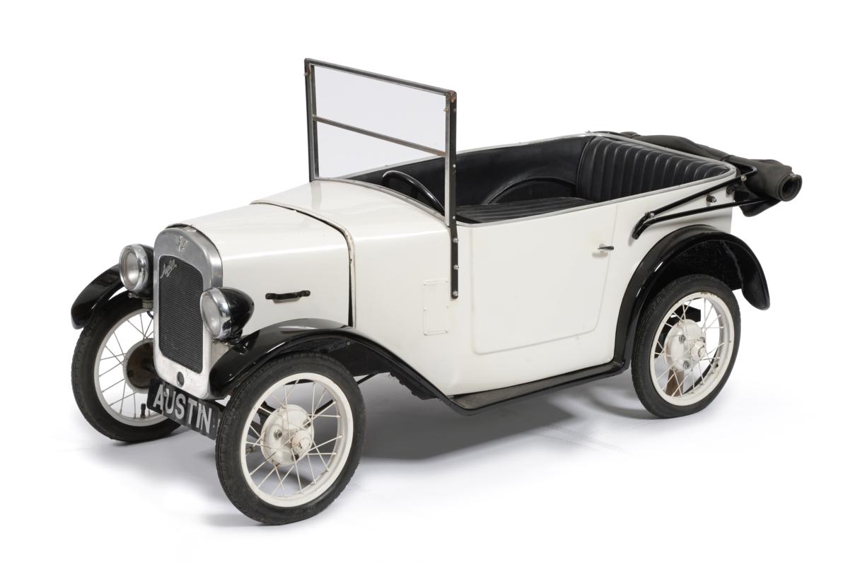 Lot 2125 - A Childs Battery Operated Model Car of an Austin 7 Chummy, painted white and black, canvas...