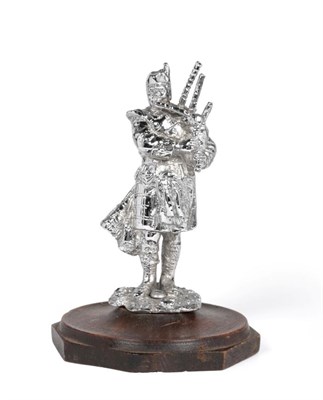 Lot 2114 - A Brass and Chrome Plated Car Mascot in the form of a Scottish Highland Piper, standing on a...