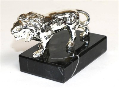 Lot 2097 - A Peugeot Chrome Car Mascot Modelled as a Lion, mounted on a black and white veined marble...