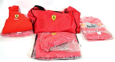 Lot 1009 - A Ferrari F1 Team Kit Bag, comprising a soft holdall numbered 014, a Puma soft bag, two pairs...