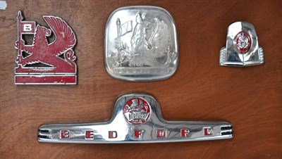 Lot 1052 - Four Chromed and Enamel Bedford Motor Vehicle Badges, mounted on a wooden board  Buyer's premium of
