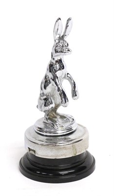 Lot 1082 - A 1930s Chrome Alvis Seated Hare Car Mascot, mounted on a radiator cap and black plastic base,...