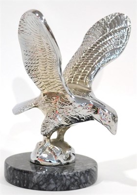 Lot 1098 - A Chrome on Brass Car Mascot in the form of an Eagle, the wings outstretched, standing on a...