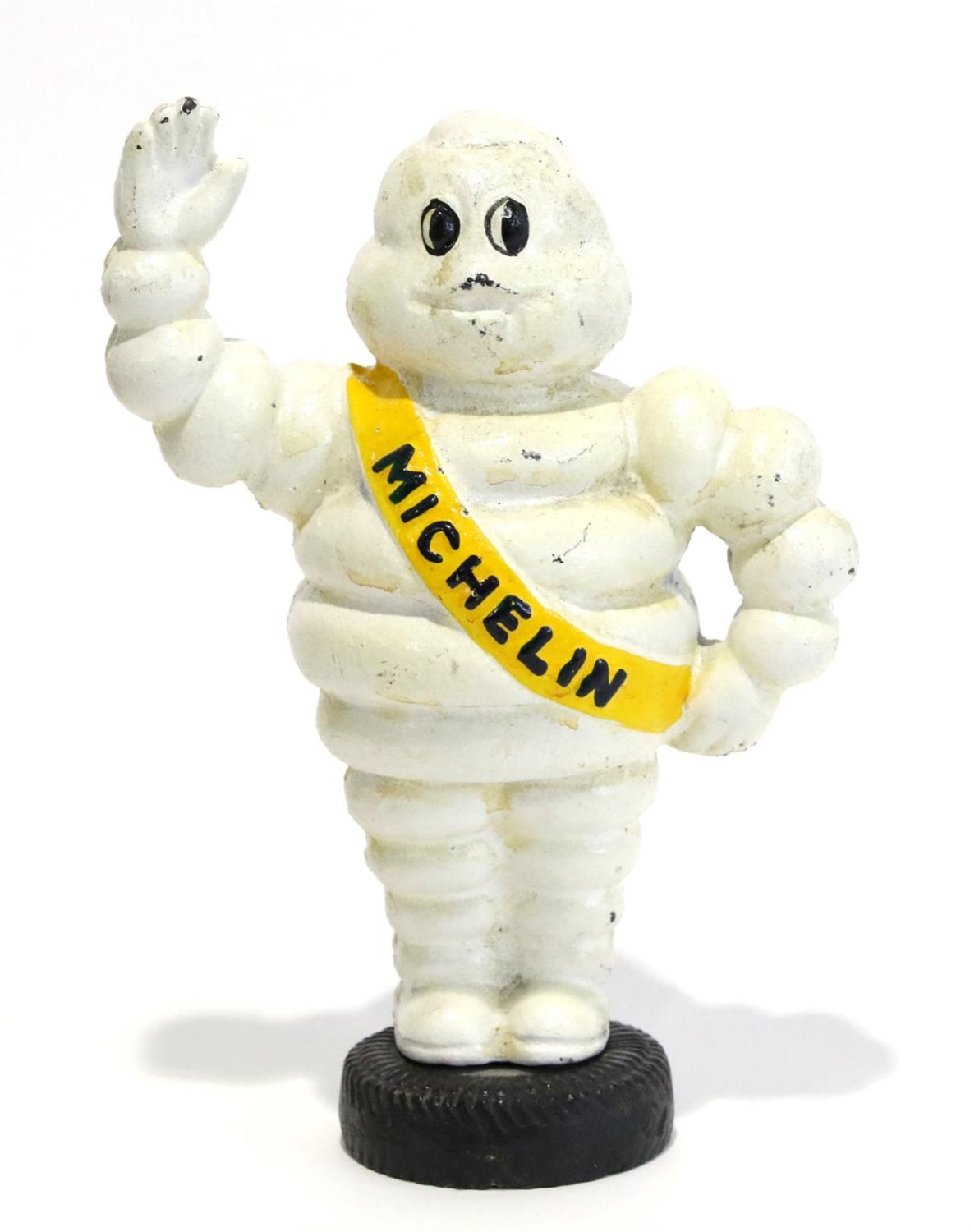 Lot 17 - A Cast Metal and White Painted Money Box modelled as the Michelin Man, standing with his hand...
