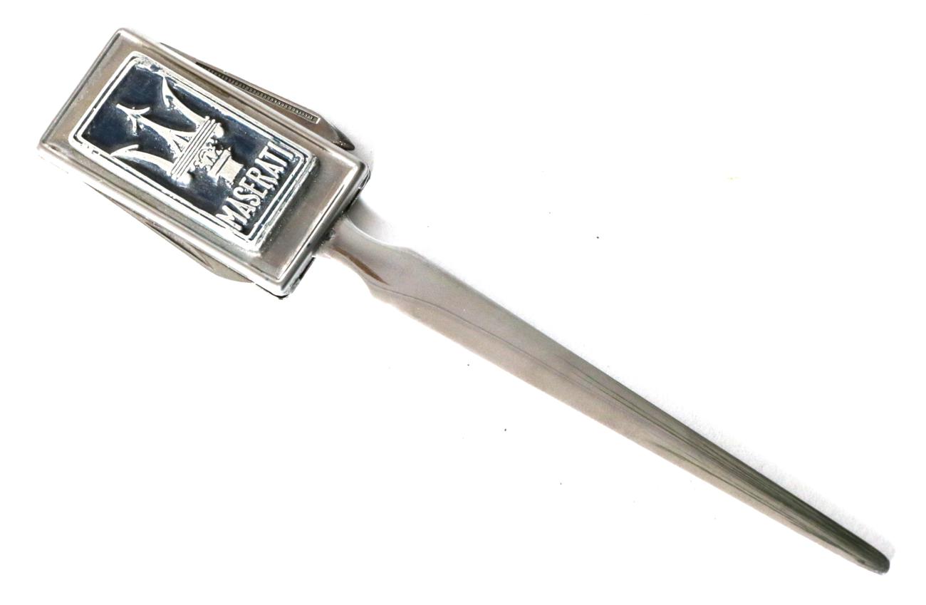 Lot 60 - A Maserati Showroom Letter Opener, 1930-50s, with twin folding pen knife blades to promote Maserati
