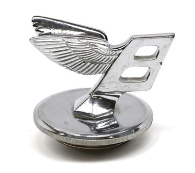 Lot 147 - A 1930s Bentley Nickel on Brass Car Mascot as a Stylised Letter B, leaning forward with wings,...