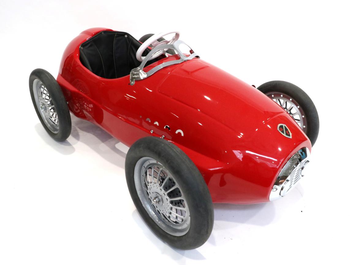Lot 259 - An Alfa Romeo Red Painted Child's Pedal Car, with white three-spoke steering wheel, chrome wind...