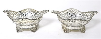 Lot 15 - A Pair of Edwardian Pierced Silver Baskets, William Comyns, London 1904, shaped oval form with twin