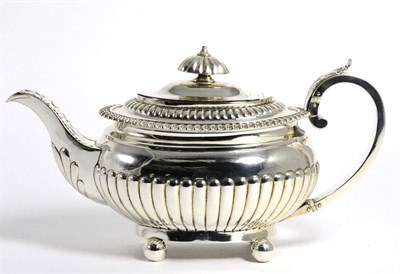 Lot 63 - A George III Regency Silver Teapot. maker's mark rubbed, London 1814, oval and half fluted,...