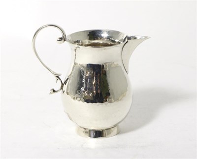 Lot 170 - A Silver Baluster Cream Jug, Stokes & Ireland, Chester 1934, with planished finish and scroll...