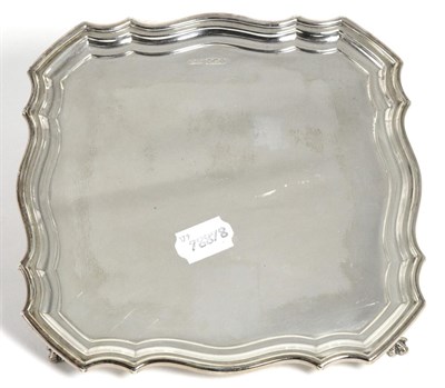 Lot 212 - A Shaped Square Silver Salver, Gladwin Ltd, Sheffield 1933, standing on four ball and claw...