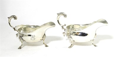 Lot 268 - Two Similar George III Style Silver Sauce Boats, London 1898 and 1902, with shaped rim, leaf capped