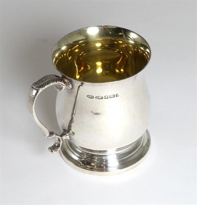 Lot 296 - A Small Silver Mug, Mappin & Webb, Sheffield 1999, baluster with leaf capped scroll handle,...