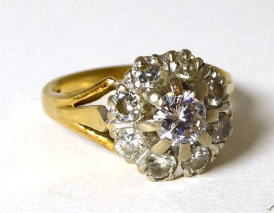 Lot 325 - A diamond cluster ring, a round brilliant cut diamond within a border of smaller round...