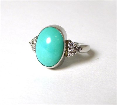 Lot 338 - An 18 carat white gold turquoise and diamond ring, the oval cabochon turquoise in a rubbed over...