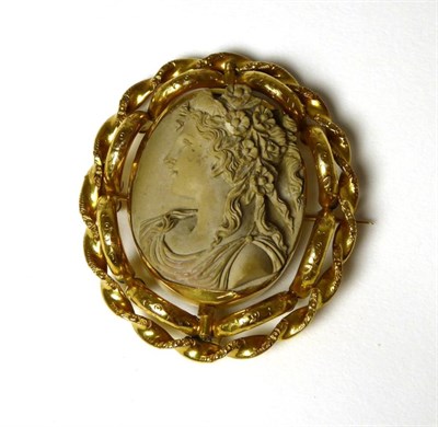 Lot 344 - A lava cameo brooch, carved in high relief with the bust of Flora, in a fancy rope frame, with...