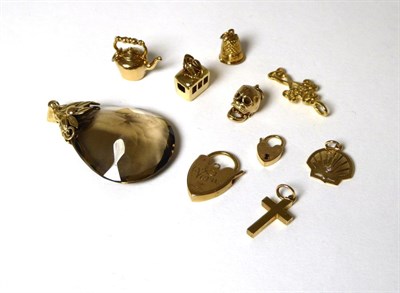 Lot 346 - A smokey quartz pendant, length 5cm and nine charms including a cross, a kettle, padlocks, a...