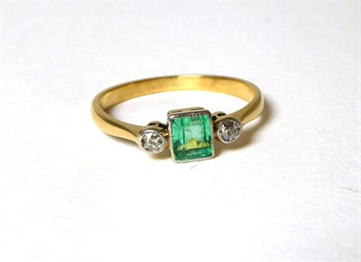Lot 349 - An emerald and diamond three stone ring, an octagonal cut emerald between two round brilliant...
