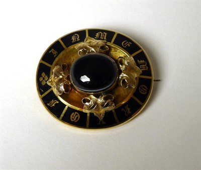 Lot 351 - A Victorian banded agate and black enamel mourning brooch, an oval cabochon black agate in a rubbed