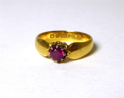 Lot 356 - A 22 carat gold ruby ring, a round cut ruby in a claw setting with a collet border, to pinched...