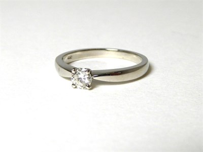 Lot 358 - A platinum solitaire diamond ring, a round brilliant cut diamond in a claw setting, to knife...