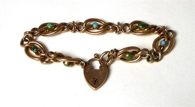 Lot 368 - A turquoise set fancy link bracelet, oval scroll links each set with an oval or round cabochon...