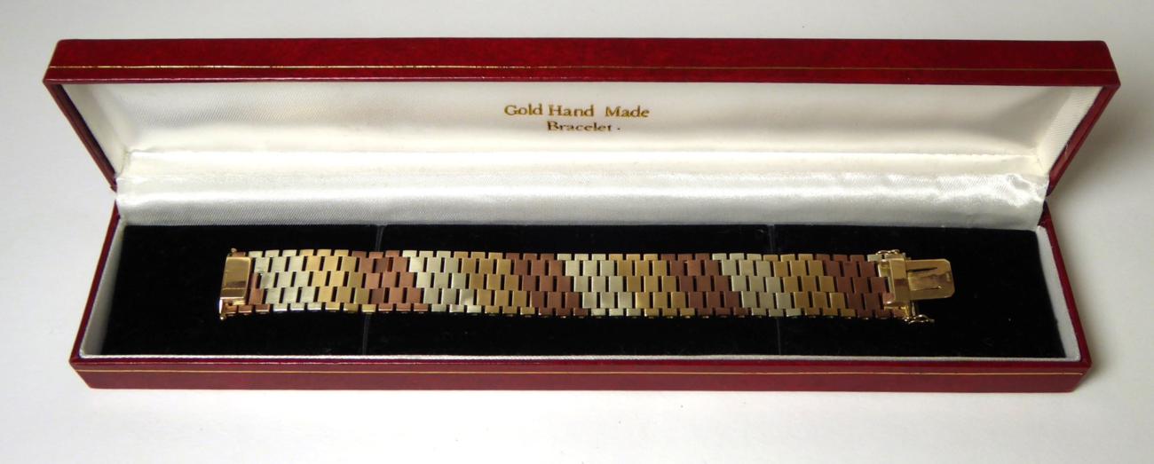 Lot 371 - A 1970s 9 carat tri-colour gold textured link bracelet, length 17cm, width 2cm