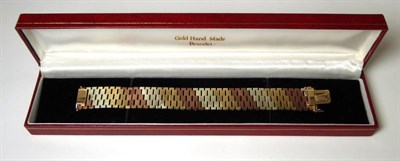 Lot 371 - A 1970s 9 carat tri-colour gold textured link bracelet, length 17cm, width 2cm