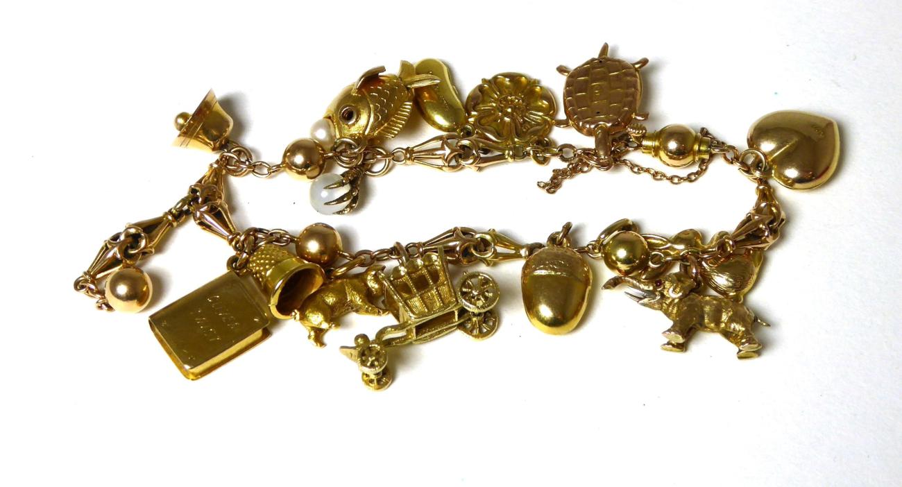 Lot 397 - A charm bracelet, hung with fifteen charms including a book stamped '9c'; a pig stamped '18ct'; a 9