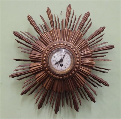 Lot 432 - A gilt wood sunburst wall timepiece