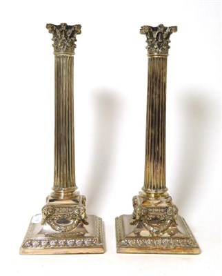 Lot 452 - A pair of Elkington electroplated Corinthian column candlesticks, later drilled for electricity