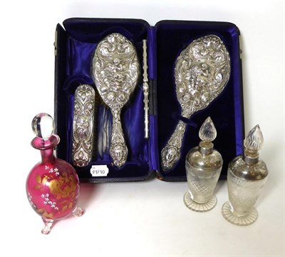 Lot 460 - A silver four piece dressing table set, by Levi and Salaman, Birmingham 1902, embossed with...