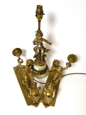 Lot 468 - Pair of cast brass wall sconces modelled as putti; and a gilt metal table lamp after the model...