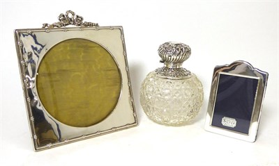 Lot 479 - An Edwardian silver photograph frame, Chester 1906, with ribbon top; a small modern example;...