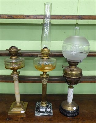 Lot 483 - Three various oil lamps, two of Corinthian column form