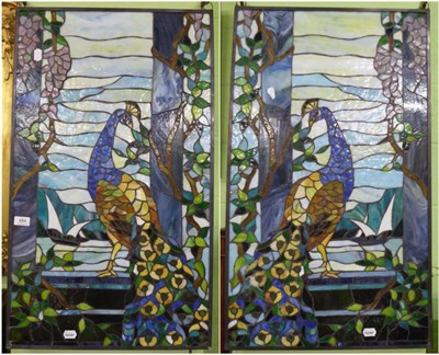 Lot 484 - A pair of stained glass panels depicting peacocks, 85cm by 50cm