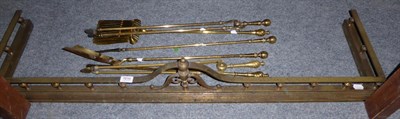 Lot 1019 - Two sets of three brass fire irons and a brass fire curb