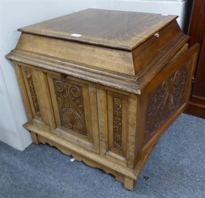 Lot 1039 - An unusual bespoke oak cabinet, 20th century, of square form with moulded top above heavily...